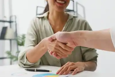 High-Quality Leads Through Smart Matchmaking. Close-up of a handshake between professionals symbolizing successful cleantech partnerships.
