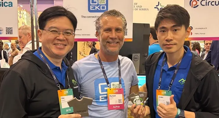 Raphaël Herrera Representing the Team at an International Event. Raphaël Herrera at a sustainability event with two other participants, all smiling and wearing badges.