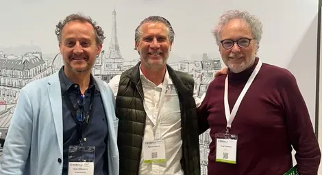 Raphaël Herrera at a GoEko Presentation Event. Raphaël Herrera standing with two colleagues at a GoEko presentation event, all wearing badges.