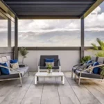 Modern hotel terrace with mountain views and sustainable outdoor furniture.